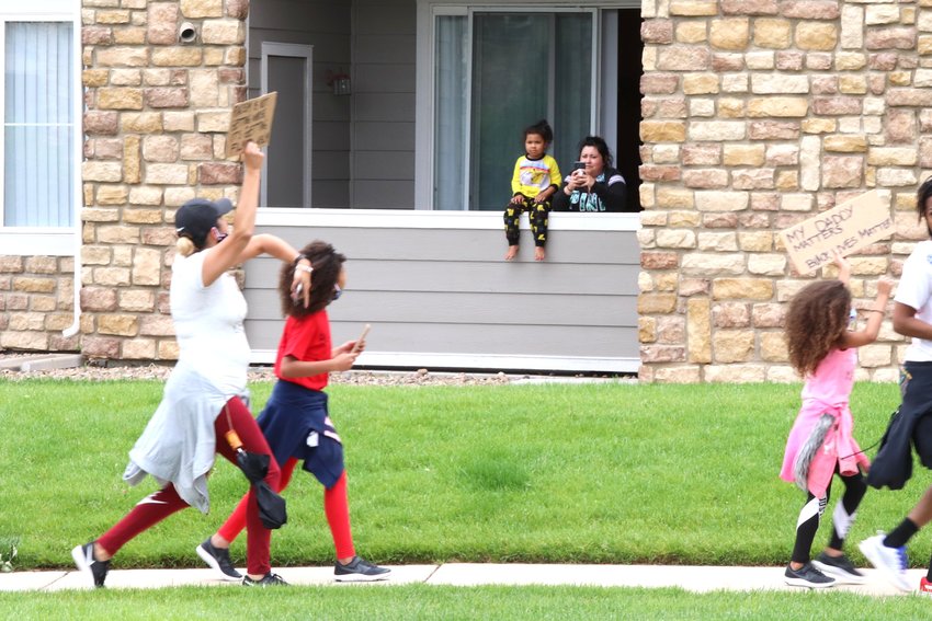 Residents of apartments along Northglenn's Community Center Drive came out of the apartments to watch a group of 65 who marched for racial justice June 6.